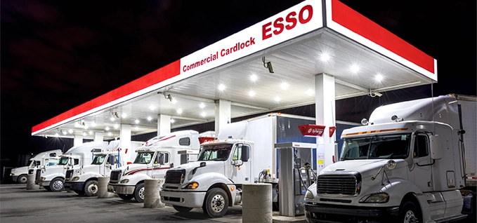 Esso Commercial Cardlock station with multiple trucks fueling at night, showing professional fleet fueling infrastructure