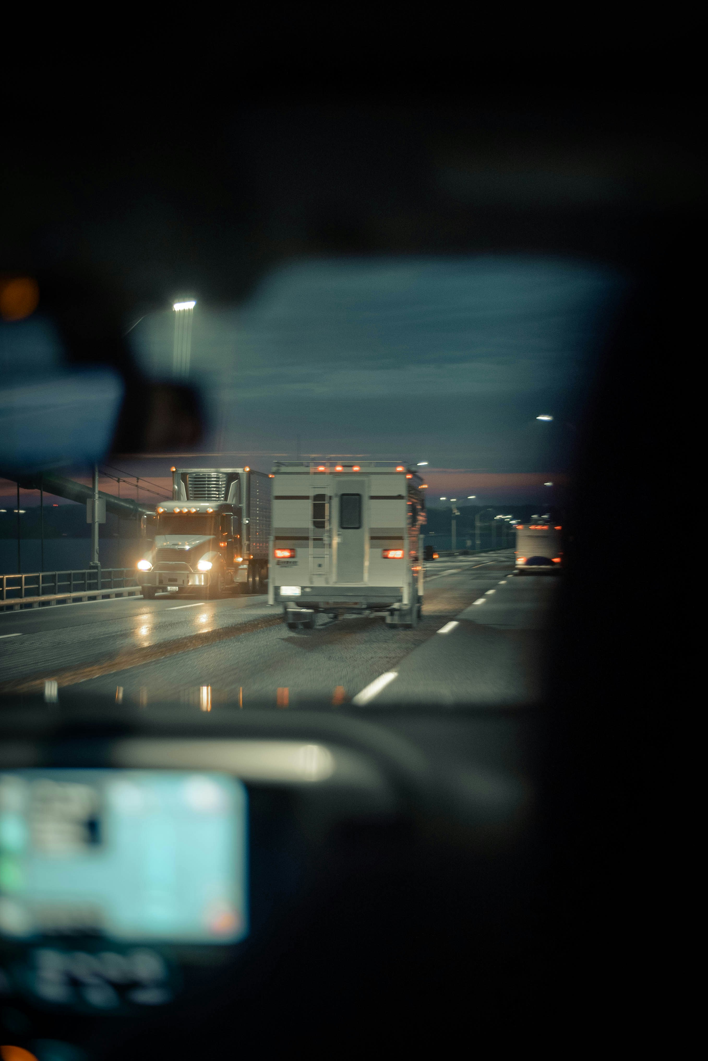 Night road trucking - driver's perspective showing professional fleet operations